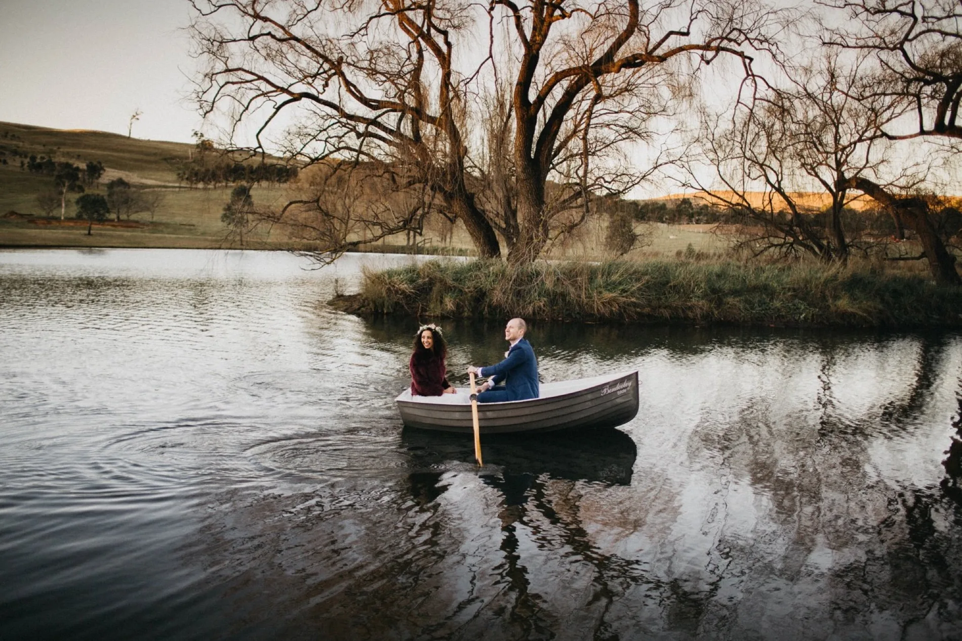 A couple paddling a canoe across still water