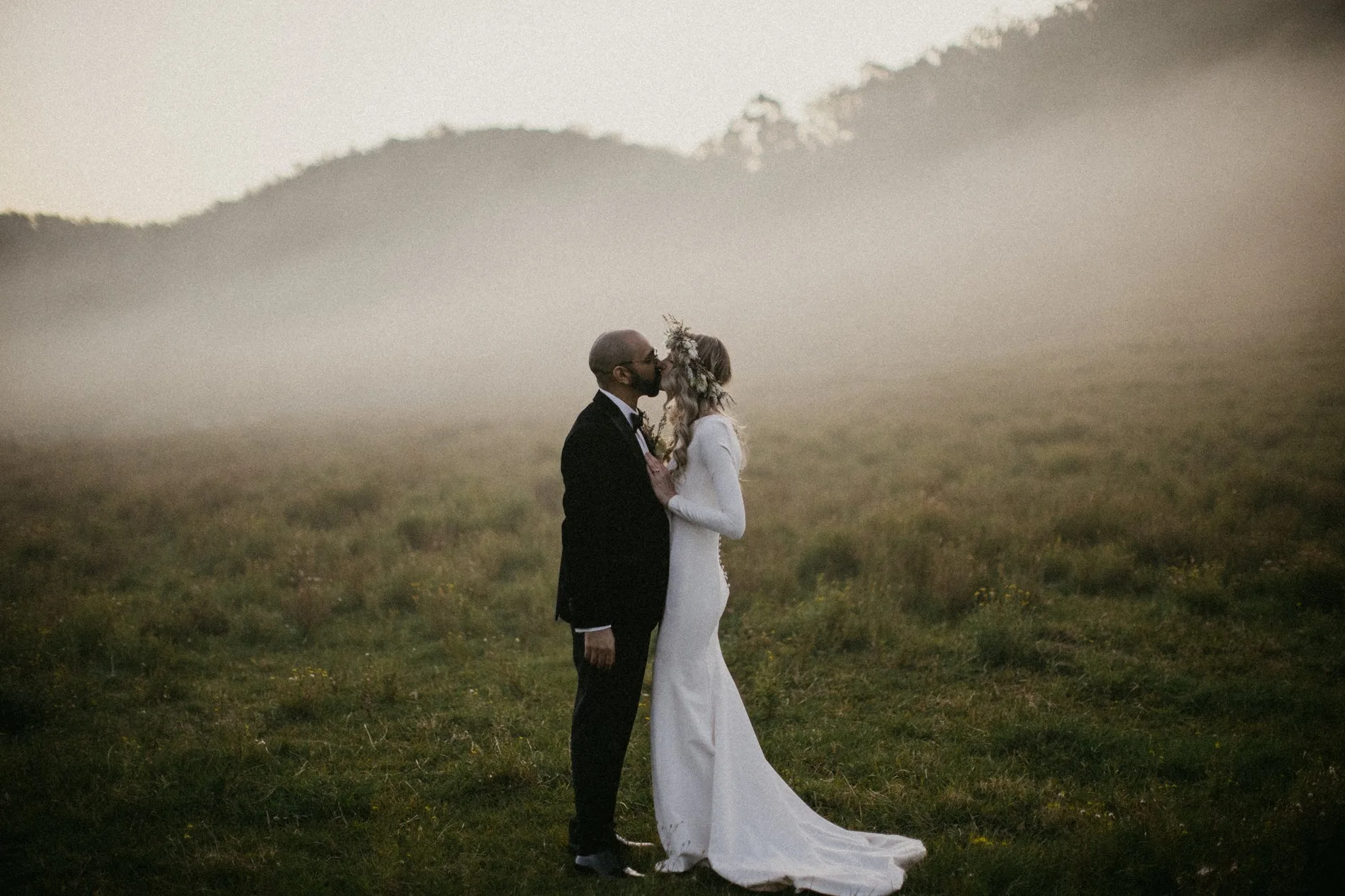 Couple holding each other in low cloud