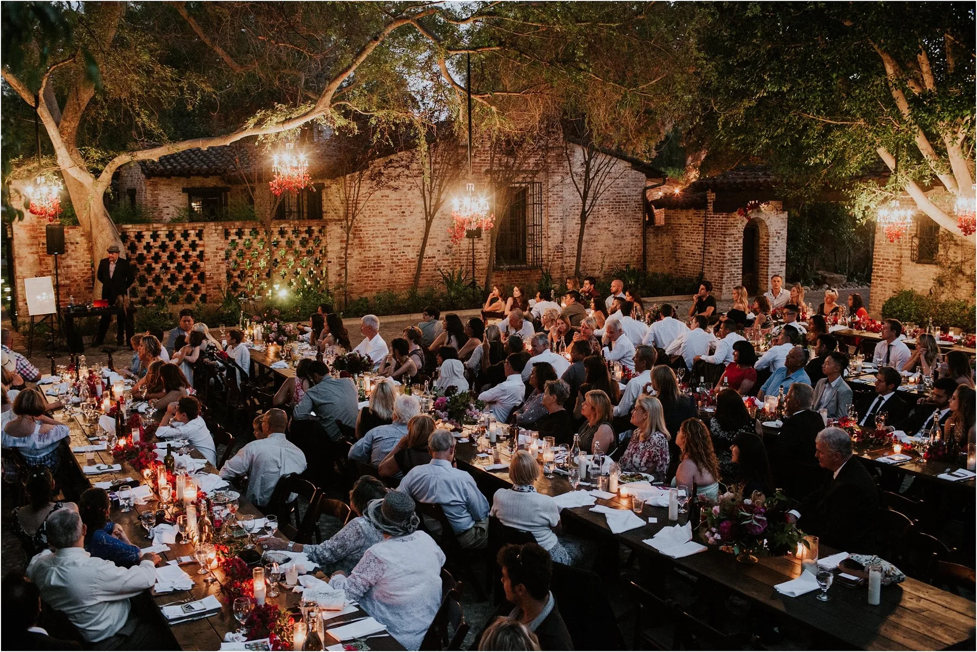 Long table reception under lights after dark