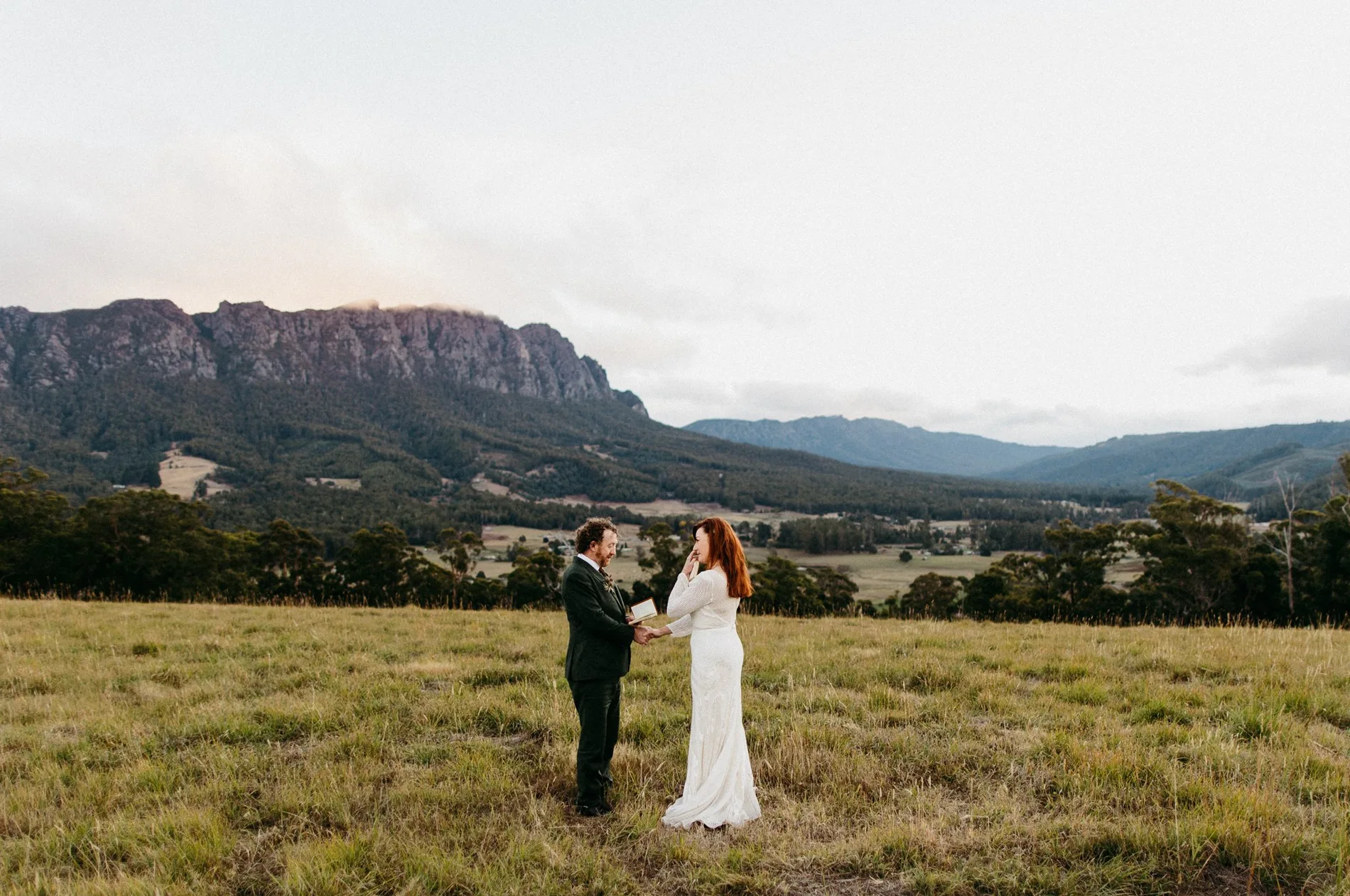 A couple exchanging vows in a vast valley